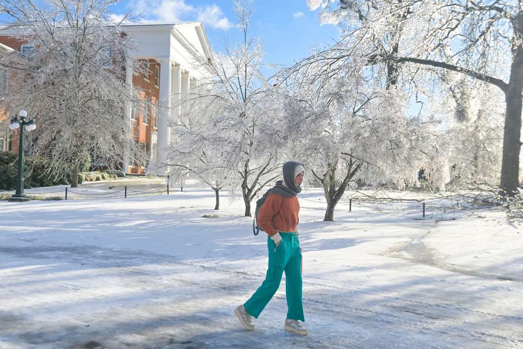 A woman walks across the campus of the University of Mississippi in Oxford, Miss. on Monday, Jan. 26, 2026, following a weekend ice storm. (AP Photo/Bruce Newman)