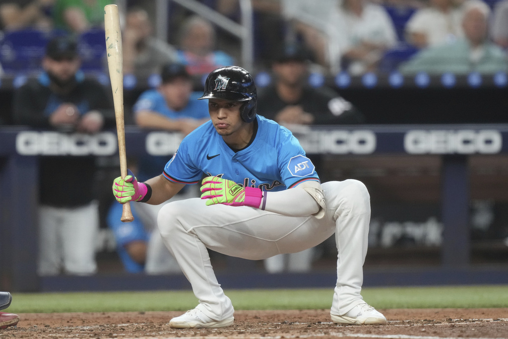 Miami Marlins' Javier Sanoja crouches down to avoid a pitch during the third inning of a baseball game against the Toronto Blue Jays, Sunday, Aug. 24, 2025, in Miami. (AP Photo/Marta Lavandier)