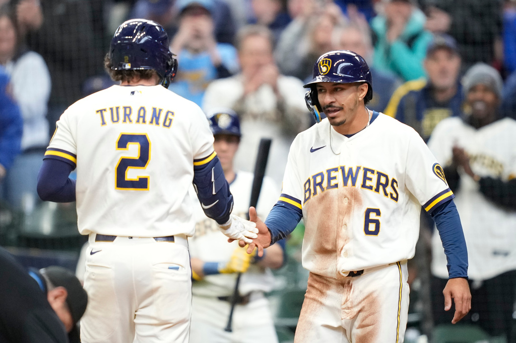 Milwaukee Brewers' David Hamilton (6) high-fives Brice Turang (2) following Turang's two-run home run during the third inning of a baseball game against the Tampa Bay Rays, Wednesday, April 1, 2026, in Milwaukee. (AP Photo/Kayla Wolf)