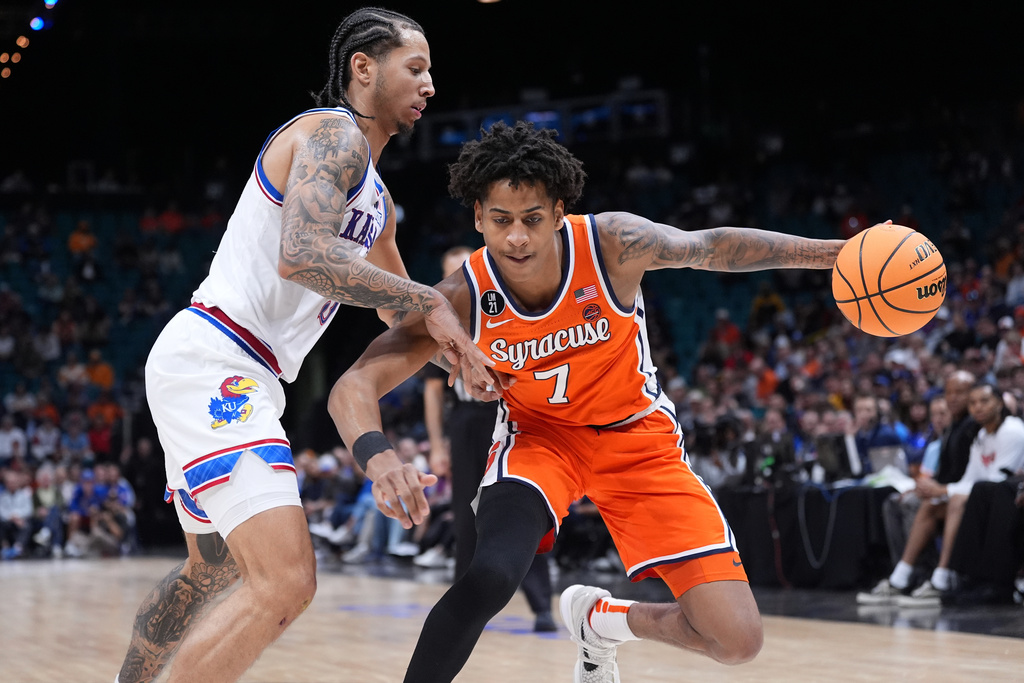 Syracuse forward Kiyan Anthony (7) drives around Kansas guard Tre White (3) during the second half of an NCAA college basketball game in the Players Era tournament Las Vegas, Tuesday, Nov. 25, 2025. (AP Photo/Eric Gay)