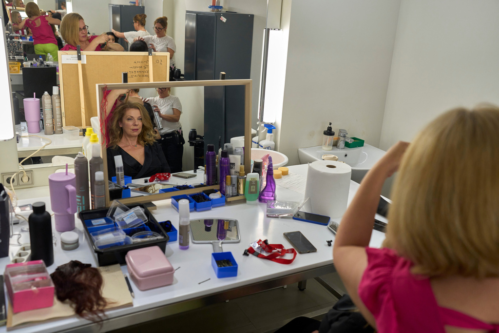 Greek mezzo-soprano Irena Athanassiou has her hair done backstage during the International Opera Awards, held at the Greek National Opera, in Athens, Thursday, Nov. 13, 2025. (AP Photo/Petros Giannakouris)