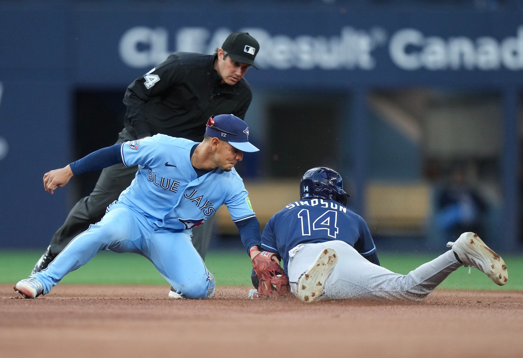 Tampa Bay Rays' Chandler Simpson (14) steals second base ahead of the tag by Toronto Blue Jays shortstop Andres Gimenez (0) during fourth inning of a baseball game in Toronto on Wednesday, July 22, 2026. (Nathan Denette/The Canadian Press via AP)