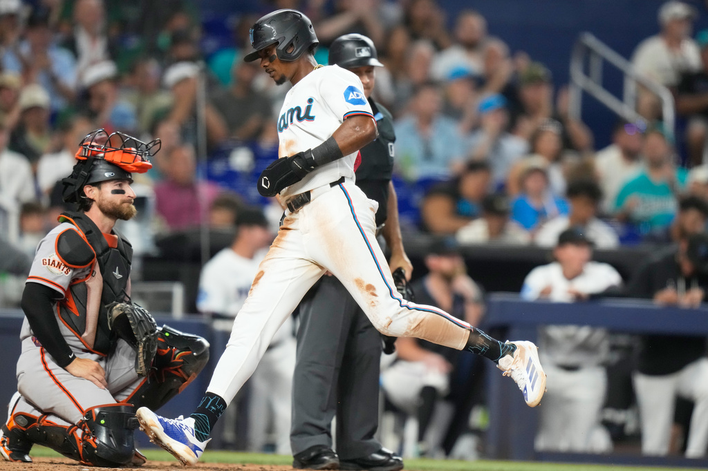 Miami Marlins' Esteury Ruiz scores on a single hit by Jakob Marsee during the fourth inning of a baseball game against the San Francisco Giants, Saturday, June 20, 2026, in Miami. (AP Photo/Lynne Sladky)