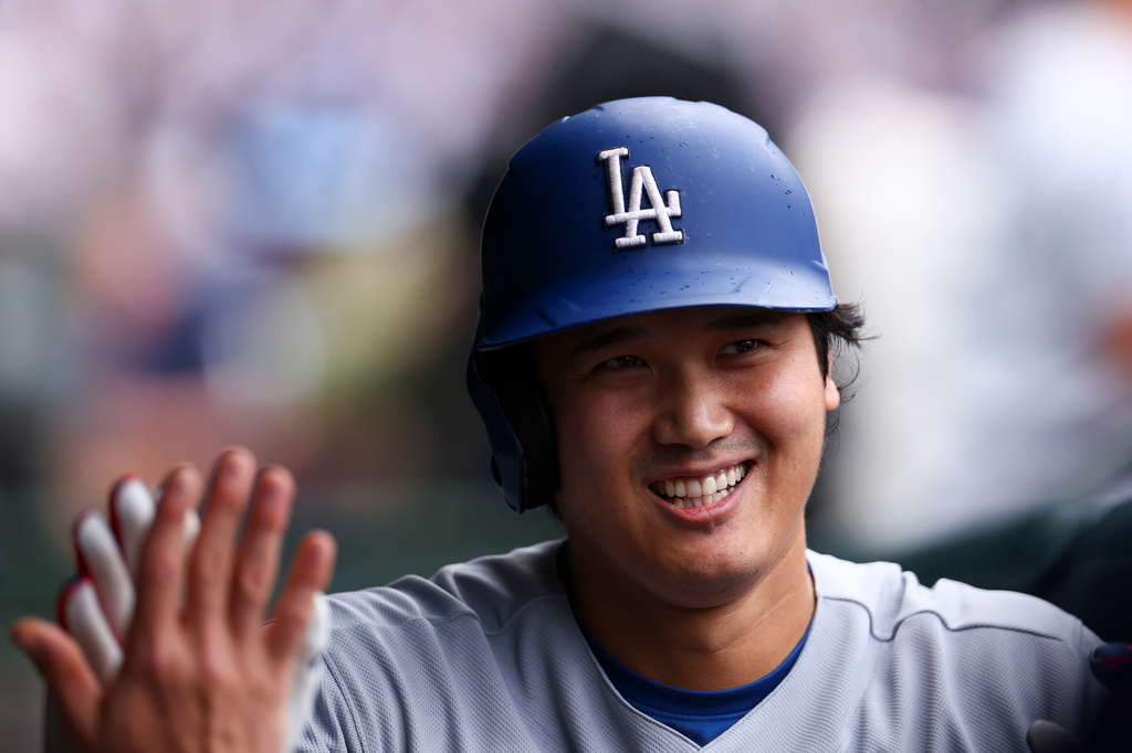 Los Angeles Dodgers designated hitter Shohei Ohtani celebrates in the dugout with teammates after hitting a home during the first inning of a baseball game against the Chicago Cubs in Chicago, Wednesday, Aug. 5, 2026. (AP Photo/Jessie Alcheh)