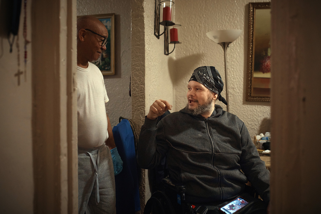Tommy Rodriguez, right, talks to his relative, Francisco Medina, left, in an apartment building where tenants report maintenance issues and pest infestations, in the Bronx borough of New York, Tuesday, March 17, 2026. (AP Photo/Andres Kudacki)
