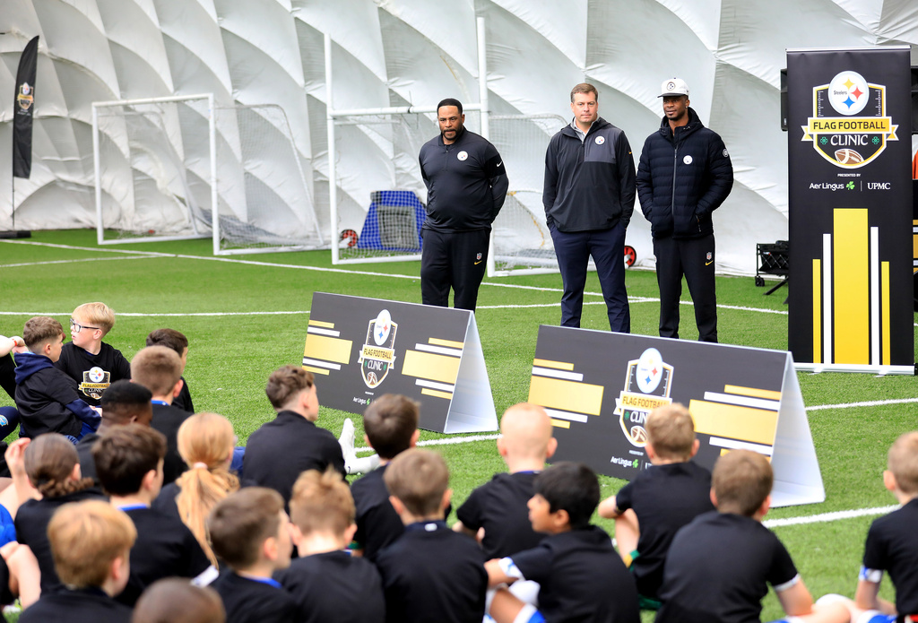From left, former Pittsburgh Steelers player Jerome Bettis, Dan Rooney and Ike Taylor Tow speak with participants at the NFL Flag Football in Belfast, Northern Ireland, Thursday, Sept 25, 2025. (Peter Morrison/AP Content Services for the NFL)