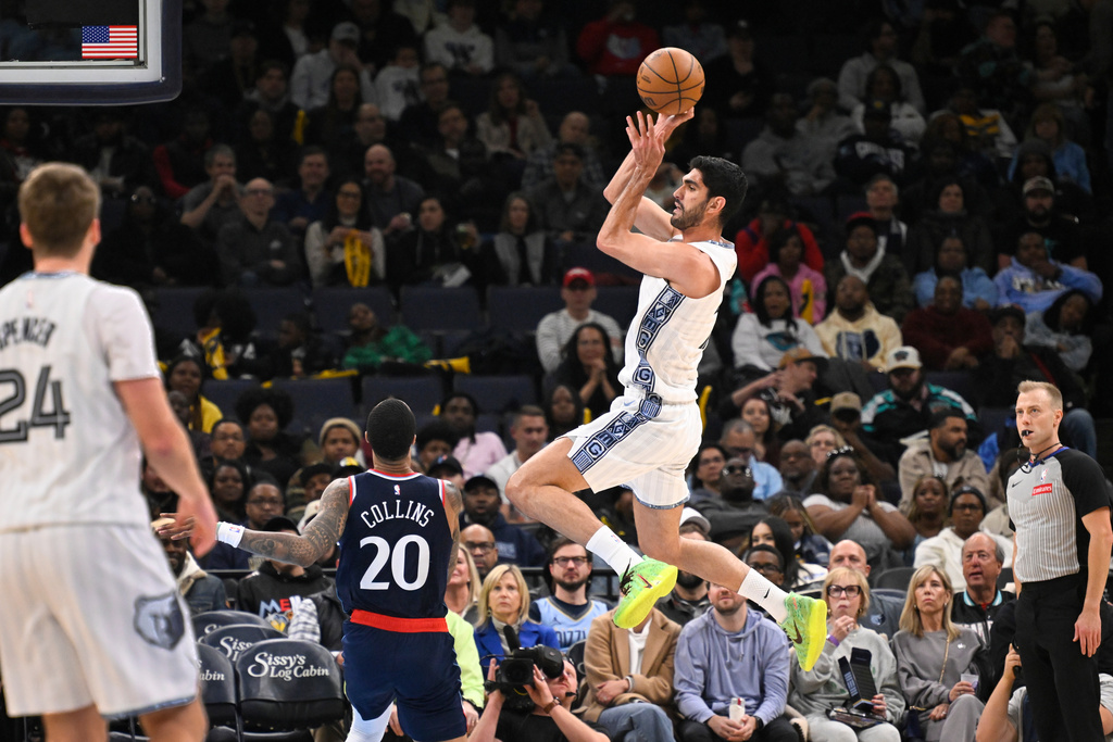 Memphis Grizzlies forward/center Santi Aldama goes high as Los Angeles Clippers forward/center John Collins (20) defends during the first half of an NBA basketball game, Friday, Dec. 5, 2025, in Memphis, Tenn. (AP Photo/John Amis)