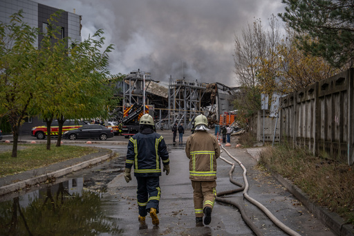 Firefighters walk towards a warehouse that caught fire following a Russian attack, Saturday, Oct. 25, 2025, in Kyiv, Ukraine. (AP Photo/Julia Demaree Nikhinson) Firefighters walk towards a warehouse that caught fire following a Russian attack, Saturday, Oct. 25, 2025, in Kyiv, Ukraine. (AP Photo/Julia Demaree Nikhinson)