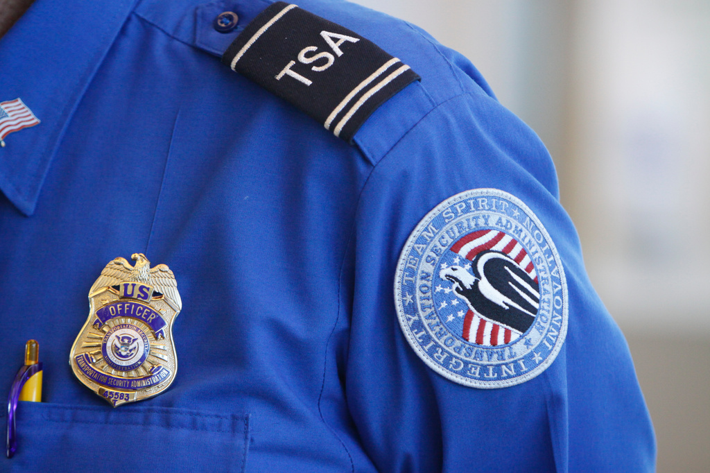 FILE -The badge and TSA logo patch are seen on the uniform of a Transportation Security Administration employee at one of the security checkpoints inside Lambert- St. Louis International Airport Oct. 7, 2010, in St. Louis. (AP Photo/Jeff Roberson, File)