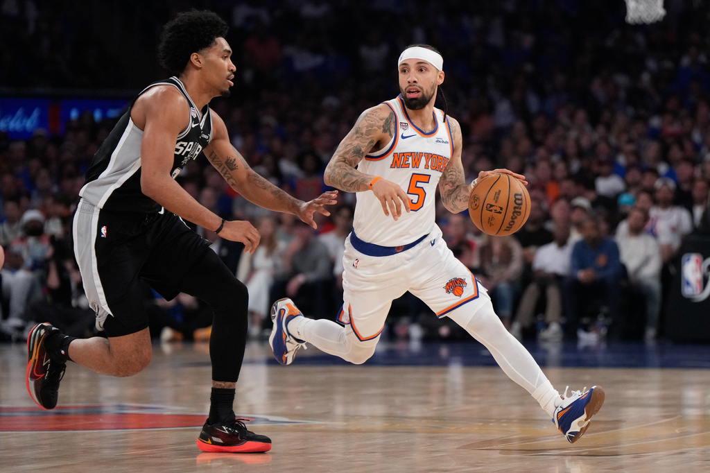 New York Knicks guard Jose Alvarado (5) drives as San Antonio Spurs guard Dylan Harper defend during the first half of Game 4 of the NBA Finals basketball series, Wednesday, June 10, 2026, in New York. (AP Photo/Ross D. Franklin)