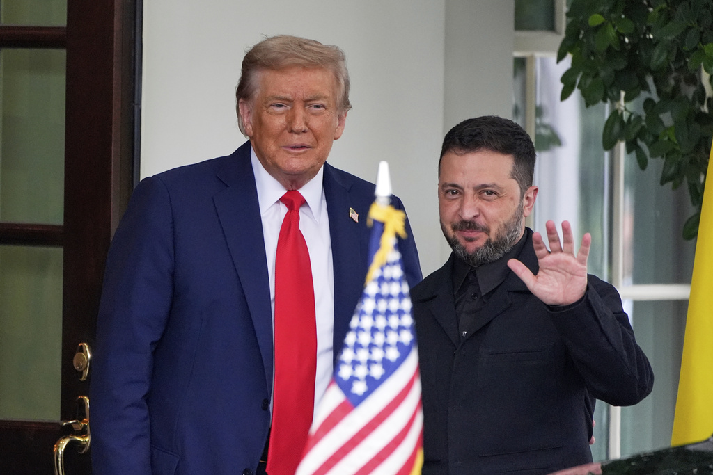 President Donald Trump, left, greets Ukraine's President Volodymyr Zelenskyy as he arrives at the White House, Monday, Aug. 18, 2025, in Washington. (AP Photo/Alex Brandon)