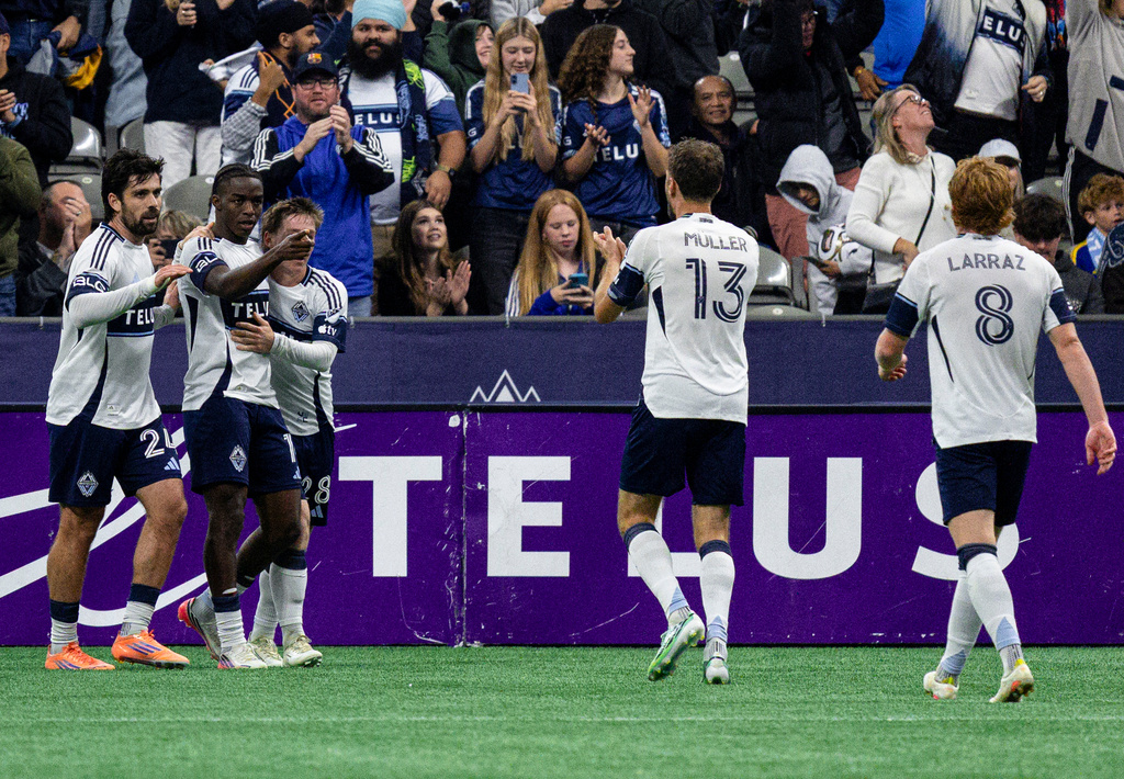 Vancouver Whitecaps' Bruno Caicedo, second from left, celebrates with teammates after scoring against D.C. United during the first half of an MLS soccer match in Vancouver, British Columbia, Saturday, Sept. 26, 2026. (Jacob Mallari/The Canadian Press via AP)