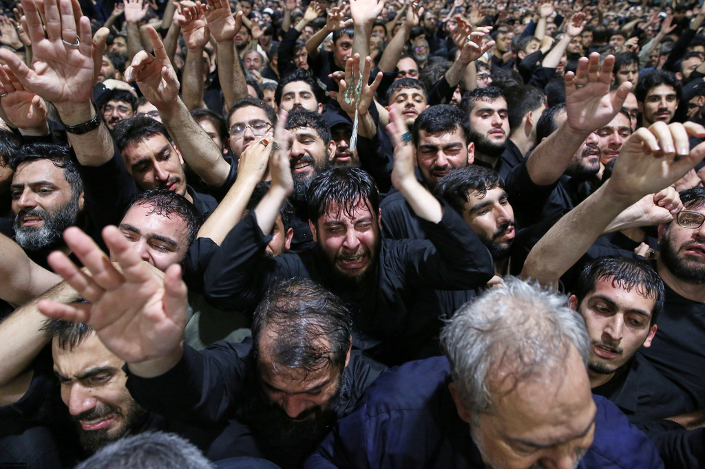 In this photo released by Iran's Supreme Leader's office, mourners react as they gather around the coffin of Iran's Supreme Leader Ayatollah Ali Khamenei as it lies in a mourning hall adjacent to the Imam Khomeini Hussainiya within the Supreme Leader's compound before his funeral in Tehran, Iran, late Thursday, July 2, 2026. (Office of the Iranian Supreme Leader via AP)