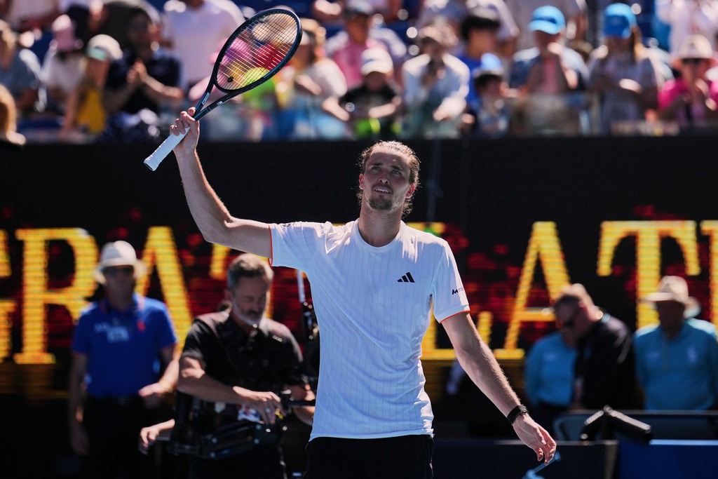 Alexander Zverev of Germany waves after defeating Gabriel Diallo of Canada in their first round match at the Australian Open tennis championship in Melbourne, Australia, Sunday, Jan. 18, 2026. (AP Photo/Dita Alangkara)