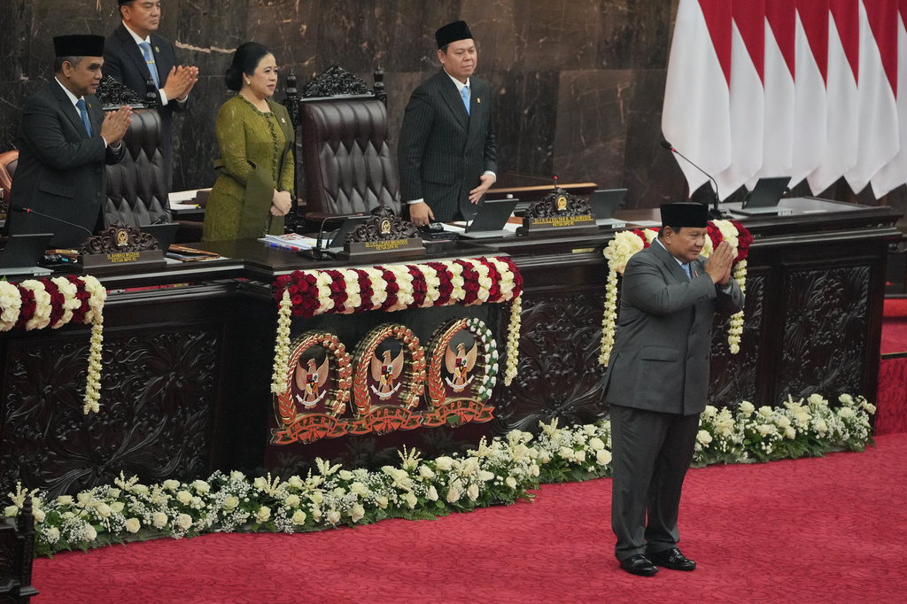 Indonesian President Prabowo Subianto, right, gestures after delivering his State of the Nation Address as, from left, the Chairman of the People's Consultative Assembly Ahmad Muzani, House Speaker Puan Maharani, and the Chairman of Regional Representative Council Sultan Bachtiar Najamudin applaud at the parliament building Jakarta, Indonesia, Friday, Aug. 14, 2026. (AP Photo/Dita Alangkara)