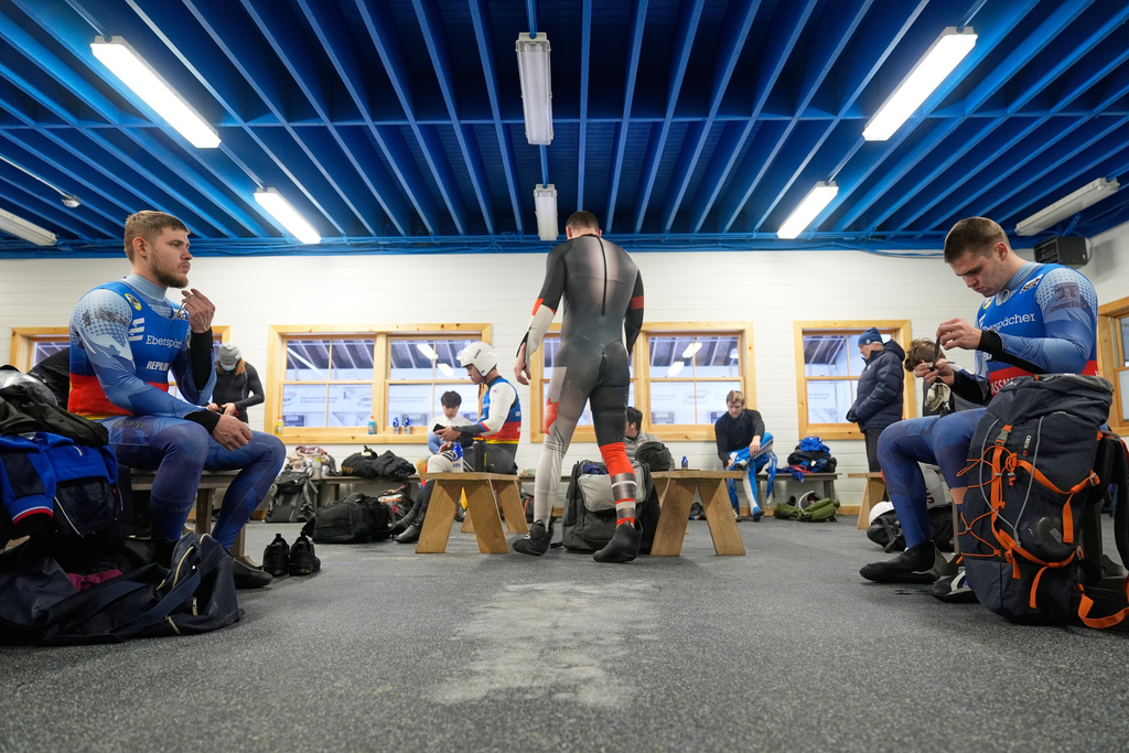 Russian luge athletes Matvei Perestoronin, right, and Pavel Repilov, left, get ready for a training run in Lake Placid, N.Y., Wednesday, Dec. 17, 2025. (AP Photo/Seth Wenig)