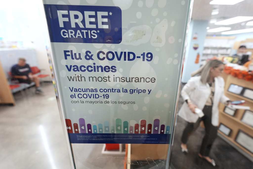 A sign advertises seasonal flu and COVID-19 vaccines at a CVS Pharmacy in Miami, Tuesday, Sept. 9, 2025. (AP Photo/Rebecca Blackwell)