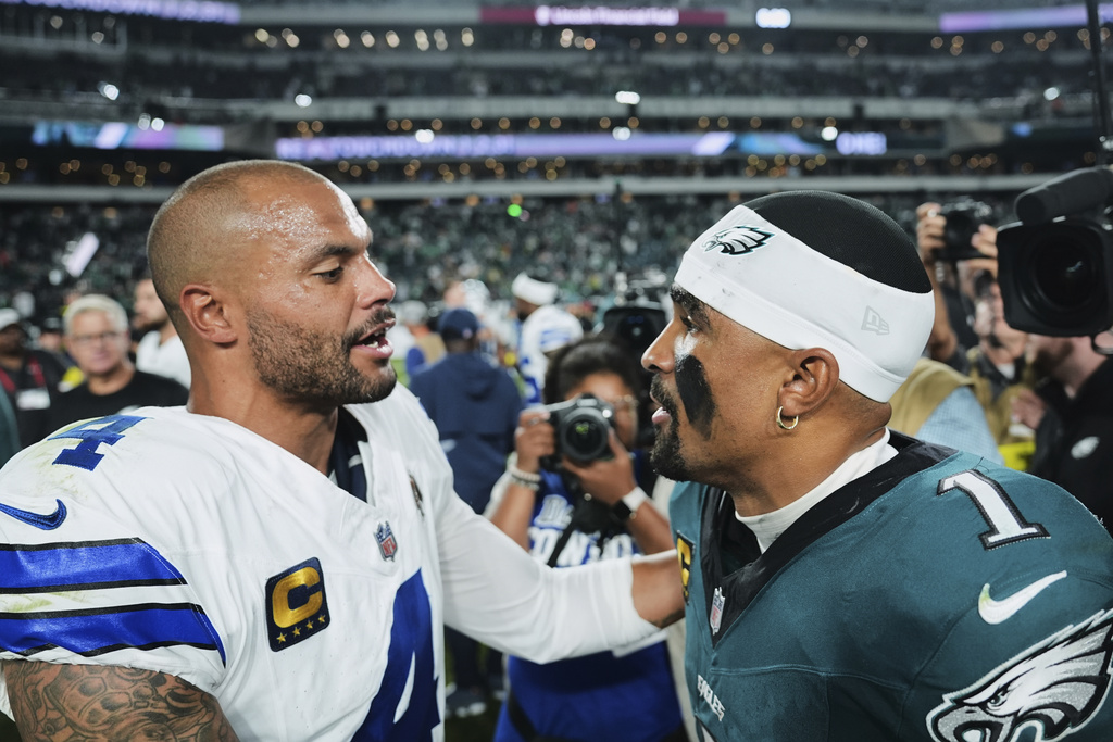Dallas Cowboys quarterback Dak Prescott (4) and Philadelphia Eagles quarterback Jalen Hurts (1) talk after their team's NFL football game Friday, Sept. 5, 2025, in Philadelphia. (AP Photo/Matt Rourke)