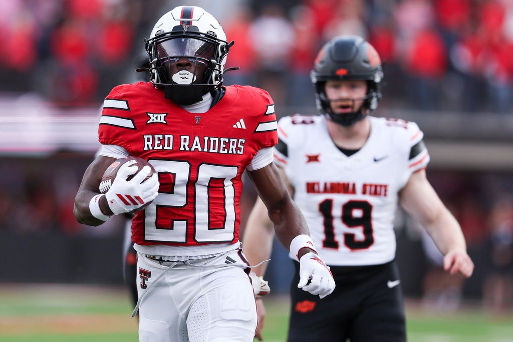 Texas Tech running back J'Koby Williams (20) returns the opening kickoff for a touchdown during the first half of an NCAA college football game against Oklahoma State, Saturday, Oct. 25, 2025, in Lubbock, Texas. (AP Photo/Chase Seabolt)
