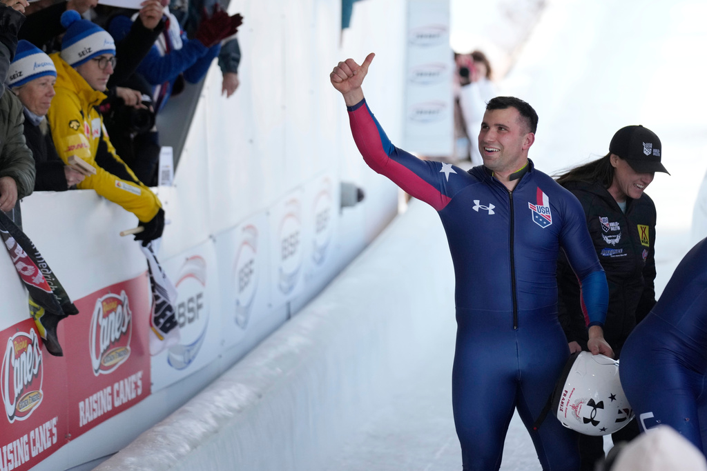 FILE -Frank del Duca, pilot of the fourth-place United States team, waves to fans after the 4-man bobsled event at the bobsled world championships, March 15, 2025, in Lake Placid, N.Y. (AP Photo/Seth Wenig, File)