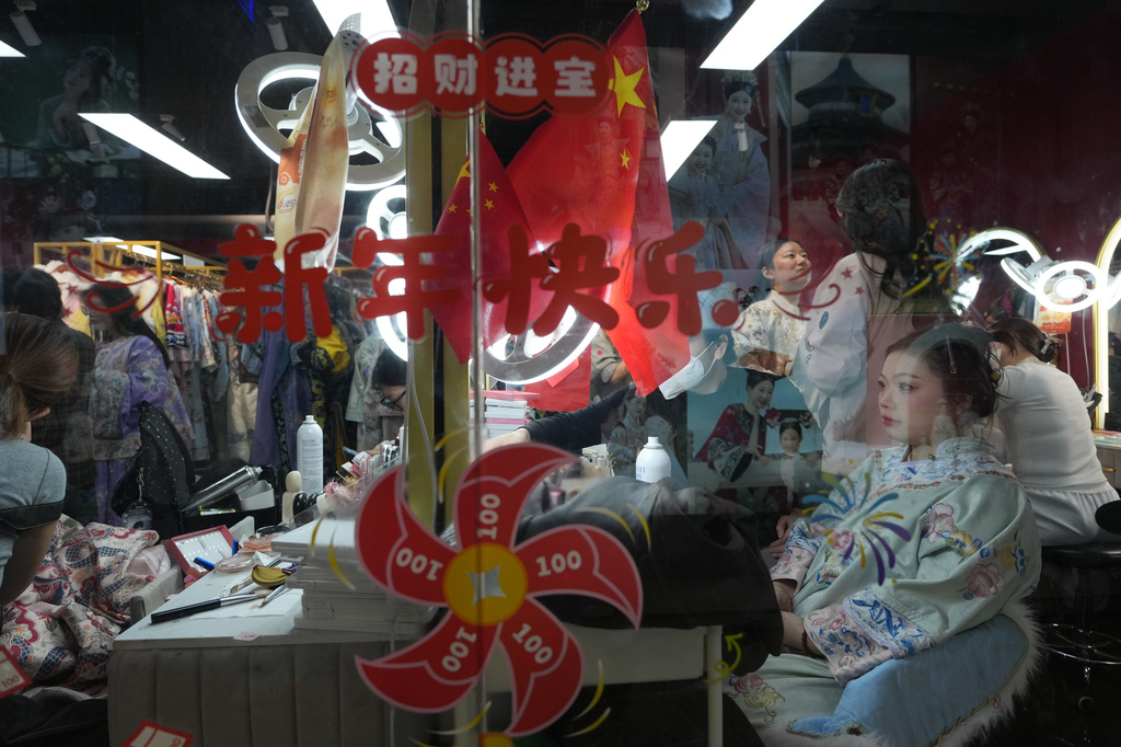 Women get made up with historical Chinese costumes at a studio near the Forbidden City in Beijing on Saturday, April 4, 2026. (AP Photo/Ng Han Guan)