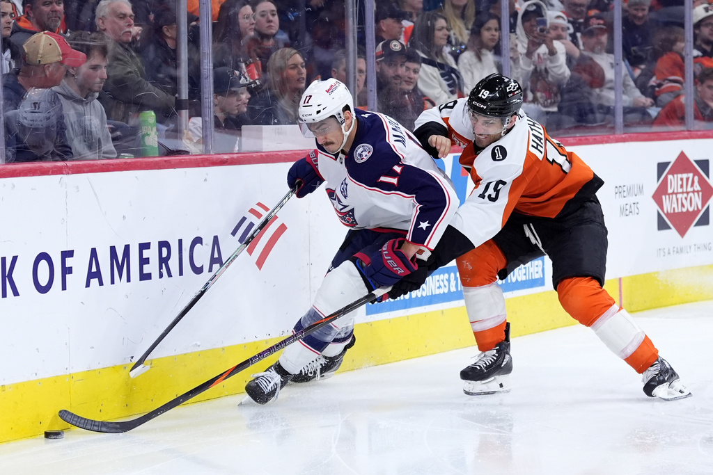 Columbus Blue Jackets' Mason Marchment, left, and Philadelphia Flyers' Garnet Hathaway battle for the puck during the second period of an NHL hockey game Tuesday, March 24, 2026, in Philadelphia. (AP Photo/Matt Slocum)