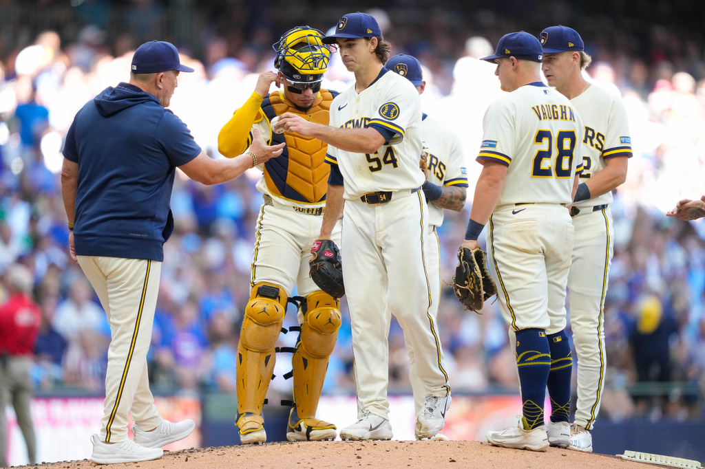 Milwaukee Brewers pitcher Robert Gasser (54) hands the ball to manager Pat Murphy, left, for a pitching change during the fifth inning of a baseball game against Chicago Cubs Monday, Sept. 7, 2026, in Milwaukee. (AP Photo/Kayla Wolf)