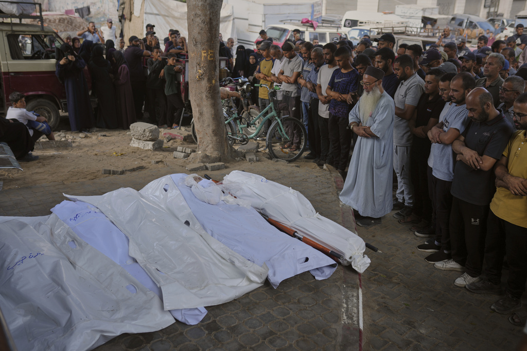 Palestinians mourn over the bodies of people who were killed in an Israeli army strike, during their funeral outside Shifa Hospital in Gaza City, Thursday, Sept. 4, 2025. (AP Photo/Jehad Alshrafi)
