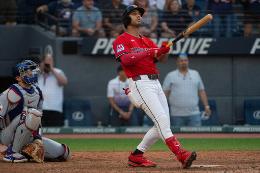 Cleveland Guardians' Brayan Rocchio, right, watches his walk off three-run home run off Texas Rangers relief pitcher Jose Corniell as Jonah Heim, left, watches during the tenth inning of a baseball game, Sunday, Sept. 28, 2025, in Cleveland. (AP Photo/Phil Long) Cleveland Guardians' Brayan Rocchio, right, watches his walk off three-run home run off Texas Rangers relief pitcher Jose Corniell as Jonah Heim, left, watches during the tenth inning of a baseball game, Sunday, Sept. 28, 2025, in Cleveland. (AP Photo/Phil Long)