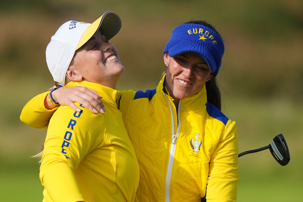 Maja Stark, left, of Europe celebrates with teammate Linn Grant on the 16th green during the Solheim Cup at the Bernardus Golf course in Den Bosch, Netherlands, Saturday, Sept. 12, 2026. (AP Photo/Alastair Grant)