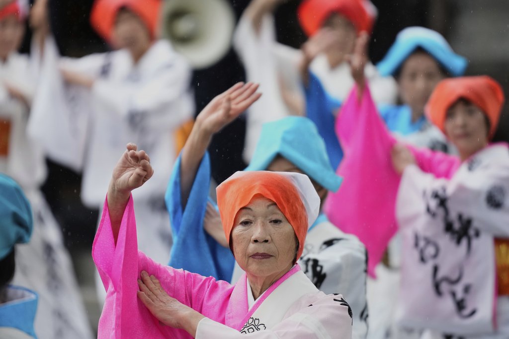 People dance in celebration of Mihishirogi Hoeishiki, a ceremony of the Shikinen Sengu ritual to rebuild main structures of the Ise Jingu shrine complex for Shinto deities, in Ise, central Japan, Monday, June 9, 2025. (AP Photo/Hiro Komae)