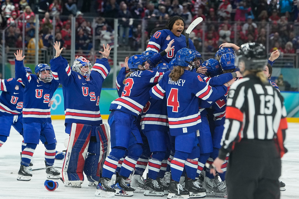 United States' players celebrate after a women's ice hockey gold medal game between the United States and Canada at the 2026 Winter Olympics, in Milan, Italy, Thursday, Feb. 19, 2026. (AP Photo/Petr David Josek)