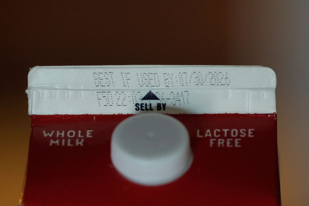 A Best If Used By date is stamped above a Sell By label on a milk carton, Tuesday, June 30, 2026, in San Francisco. (AP Photo/Jeff Chiu)