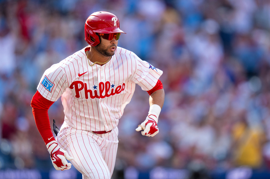 Philadelphia Phillies' Justin Crawford runs to first after hitting a single for his first major league at bat during the second inning of an opening-day baseball game against the Texas Rangers, Thursday, March 26, 2026, in Philadelphia. (AP Photo/Chris Szagola)