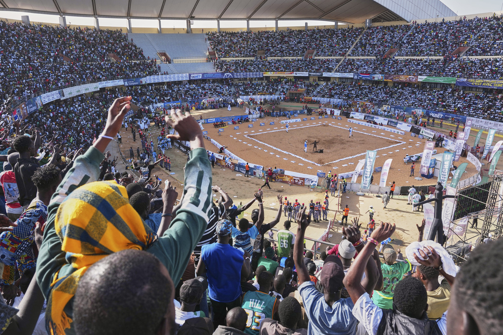 Fans attend a wrestling competition at the National Arena in Dakar, Senegal, Sunday, April 5, 2026. (AP Photo/Misper Apawu)