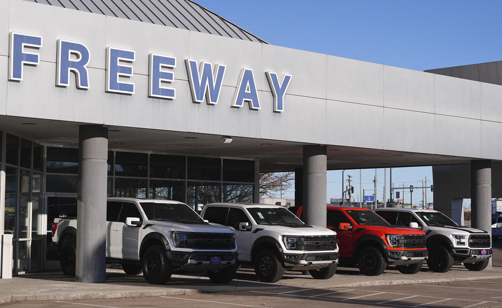 FILE - A long line of unsold 2024 pickup trucks sit on display at Ford dealership Thursday, Nov. 28, 2024, in southeast Denver. (AP Photo/David Zalubowski, File)