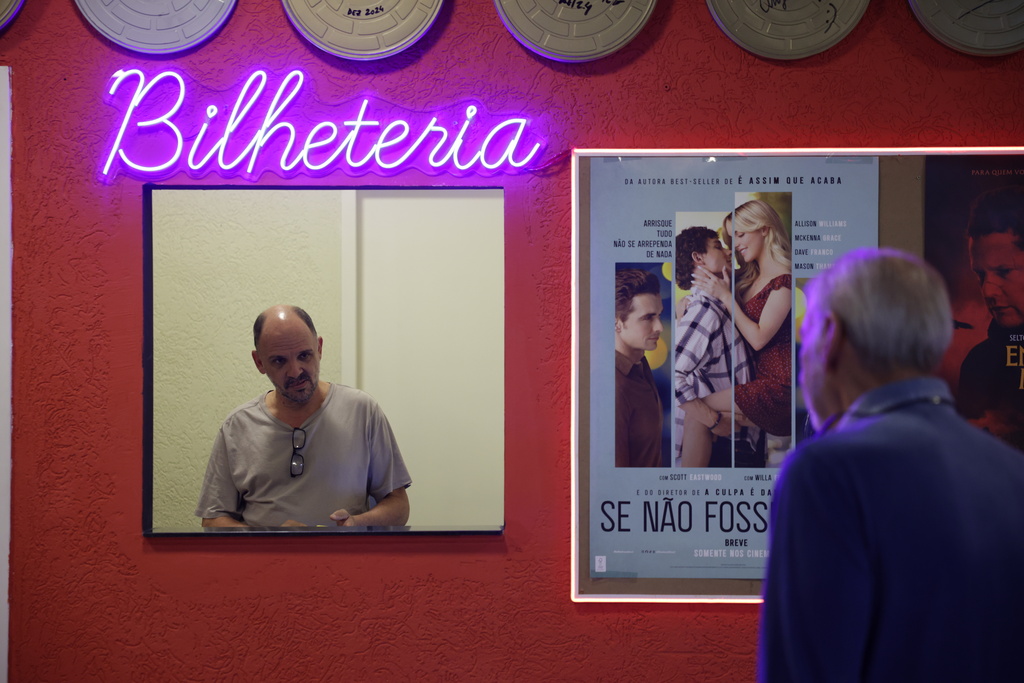 Carlos Costa sells movie tickets at his Cine LT3 in an old parking garage in Sao Paulo, Thursday, Oct. 9, 2025. (AP Photo/Ettore Chiereguini)