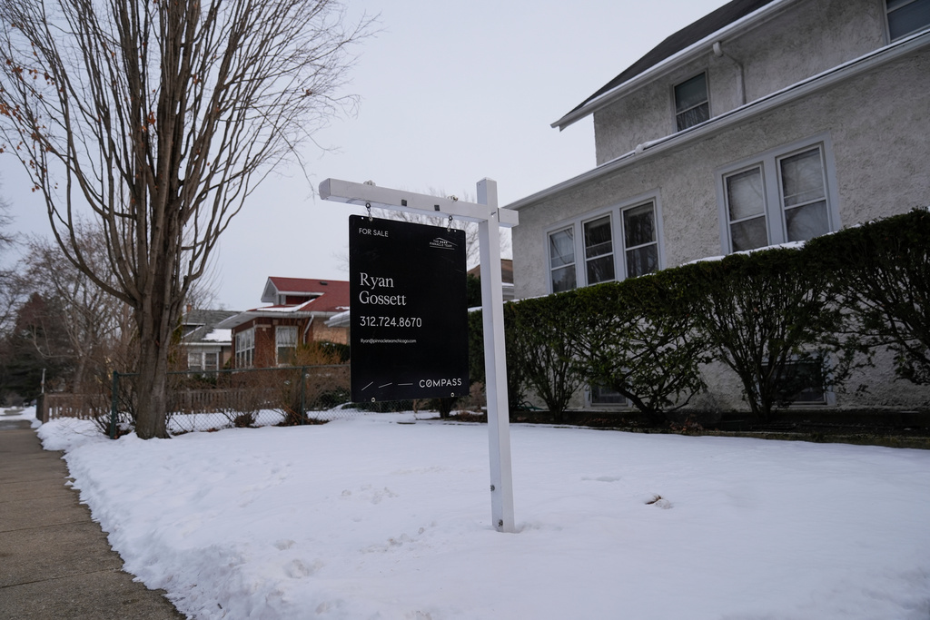 A for sale sign is posted outside a home Monday, Feb. 9, 2026, in Chicago. (AP Photo/Erin Hooley)