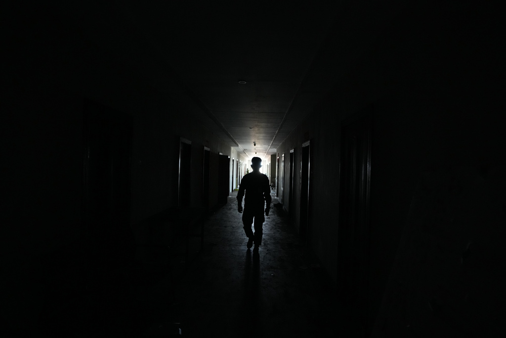 A Thai soldier walks at a at scam compound in O'Smach, Cambodia, Monday, Feb. 2, 2026, (AP Photo/Sakchai Lalit)