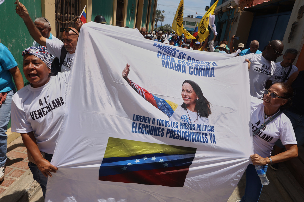 Supporters of opposition leader Maria Corina Machado attend a rally calling for her return to the country, in La Guaira, Venezuela, Sunday, Sept. 27, 2026. (AP Photo/Pedro Mattey)