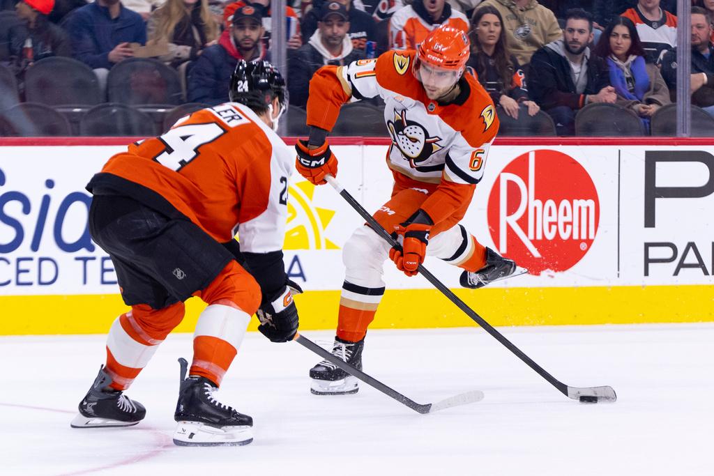 Anaheim Ducks' Cutter Gauthier, right, shoots the puck against Philadelphia Flyers' Nick Seeler, left, during the first period of an NHL hockey game, Tuesday, Jan. 6, 2026, in Philadelphia. (AP Photo/Chris Szagola)