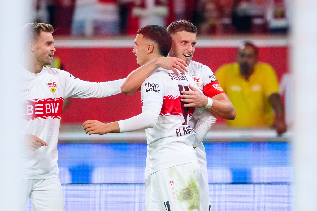 Stuttgart's Bilal El Khannouss, center, celebrates scoring with Maximilian Mittelstädt, left, and Ermedin Demirovic during the Bundesliga soccer match between VfB Stuttgart and FC St. Pauli, at MHPArena, Stuttgart, Germany, Friday Sept. 19, 2025. (Tom Weller/dpa via AP)