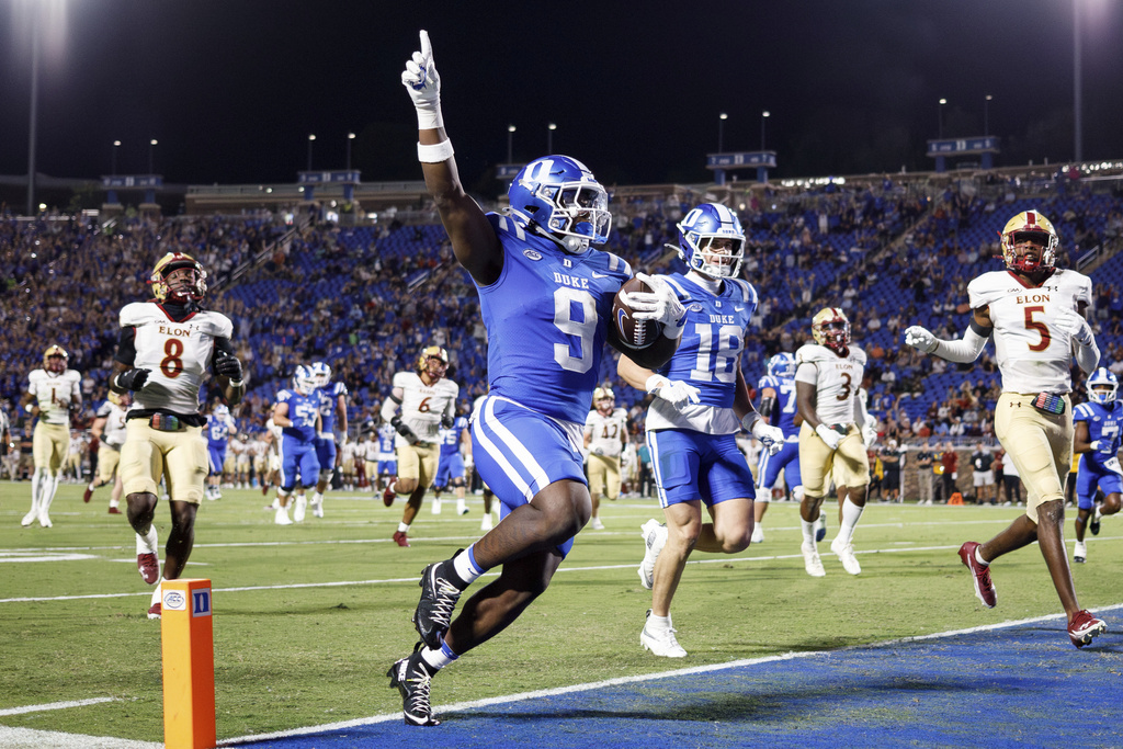 Duke's Jaquez Moore (9) carries the ball for a touchdown during the first half of an NCAA college football game against Elon in Durham, N.C., Thursday, Aug. 28, 2025. (AP Photo/Ben McKeown)
