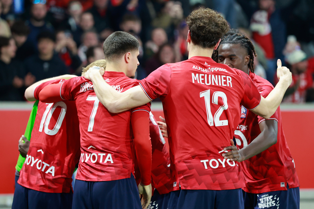 Lille's Felix Correia celebrates with teammates after scoring his side's second goal during the French League One soccer match between Lille and Lens, in Lille, France, Saturday, April 4, 2026. (AP Photo/Jean-Francois Badias)