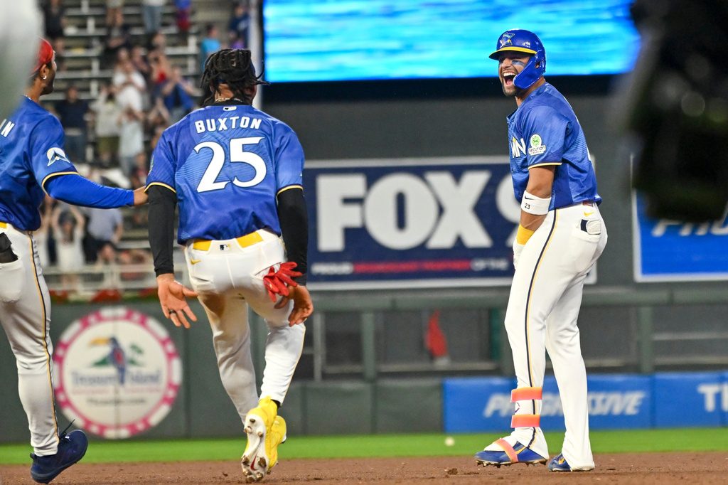 Minnesota Twins' Royce Lewis, right, celebrates with Byron Buxton (25) after hitting a walkoff single against the Colorado Rockies during the 10th inning of a baseball game Friday, June 26 2026, in Minneapolis. (AP Photo/Craig Lassig)