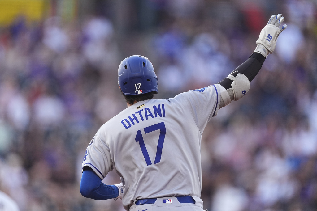 Los Angeles Dodgers' Shohei Ohtani gestures to the bullpen as he circles the bases after hitting a solo home run off Colorado Rockies starting pitcher Austin Gomber in the second inning of a baseball game Tuesday, Aug. 19, 2025, in Denver. (AP Photo/David Zalubowski)