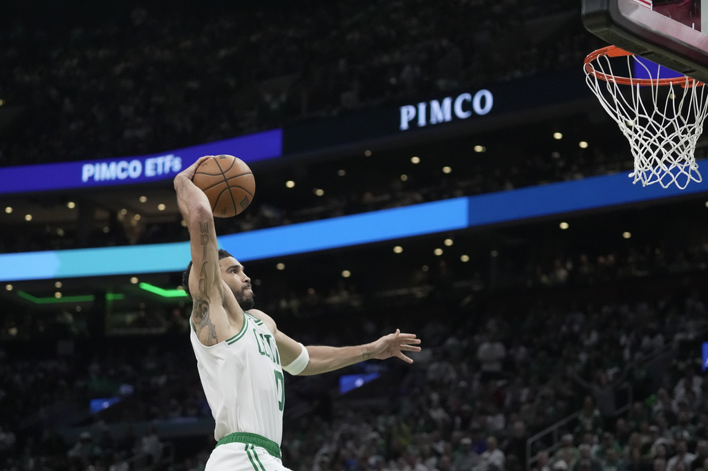 Boston Celtics forward Jayson Tatum goes in for a dunk against the Philadelphia 76ers during the first half in Game 1 of a first-round NBA playoffs basketball game, Sunday, April 19, 2026, in Boston. (AP Photo/Robert F. Bukaty)