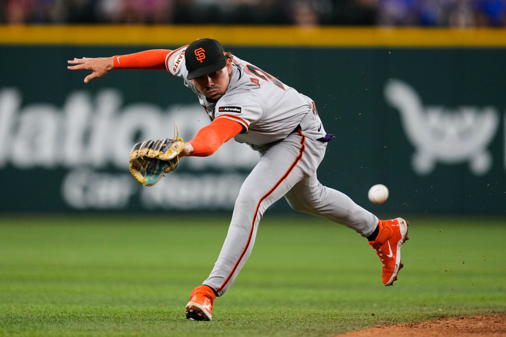San Francisco Giants shortstop Willy Adames is unable to reach a single by Texas Rangers' Ezequiel Duran in the fourth inning of a baseball game in Arlington, Texas, Monday, Aug. 3, 2026. (AP Photo/Tony Gutierrez)