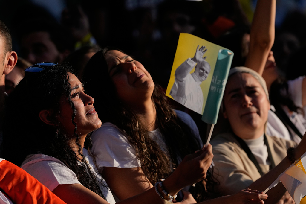 People wait for Pope Leo XIV in Plaza de Lima in Madrid, Saturday, June 6, 2026, for a prayer vigil with young people on the first day of Leo's seven-day apostolic journey to mainland Spain and the Canary Islands. (AP Photo/Alessandra Tarantino)