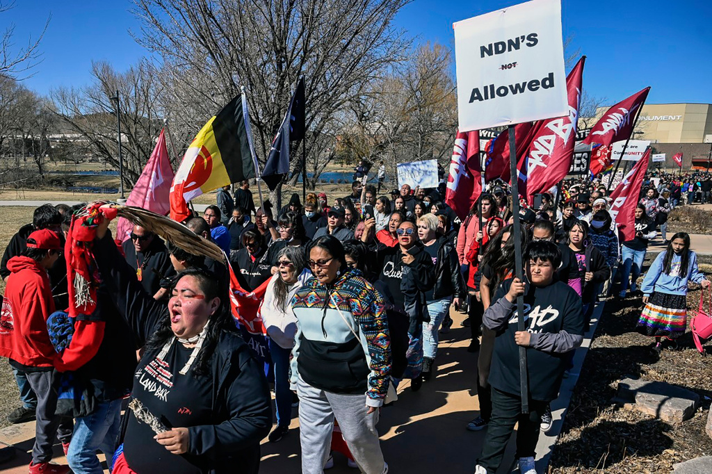 FILE - Demonstrators march from Memorial Park to the Andrew W. Bogue Federal building on Wednesday, March 23, 2022, in Rapid City, S.D., where it was announced that a federal civil rights lawsuit was filed against the Grand Gateway Hotel for denying services to Native Americans. (Matt Gade/Rapid City Journal via AP, File)